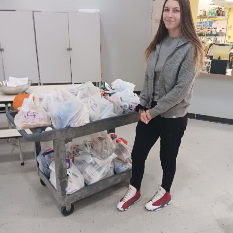 A volunteer delivers food from a food drive to the Brisbane homeless center in Fredericksburg, Virginia.