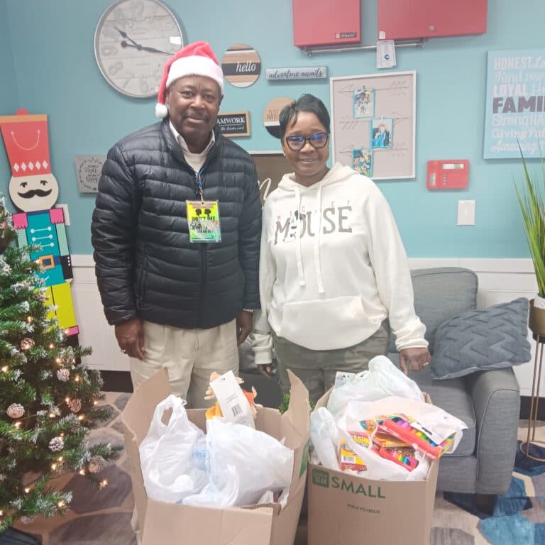 Coach Reggie delivers boxes of school supplies to a local day care center in Stafford, Virginia.