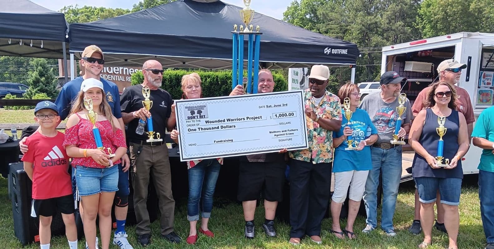 Cathy Lynn joins Mothers and Fathers Against Crime as they present a check to the Wounded Warriors Project.